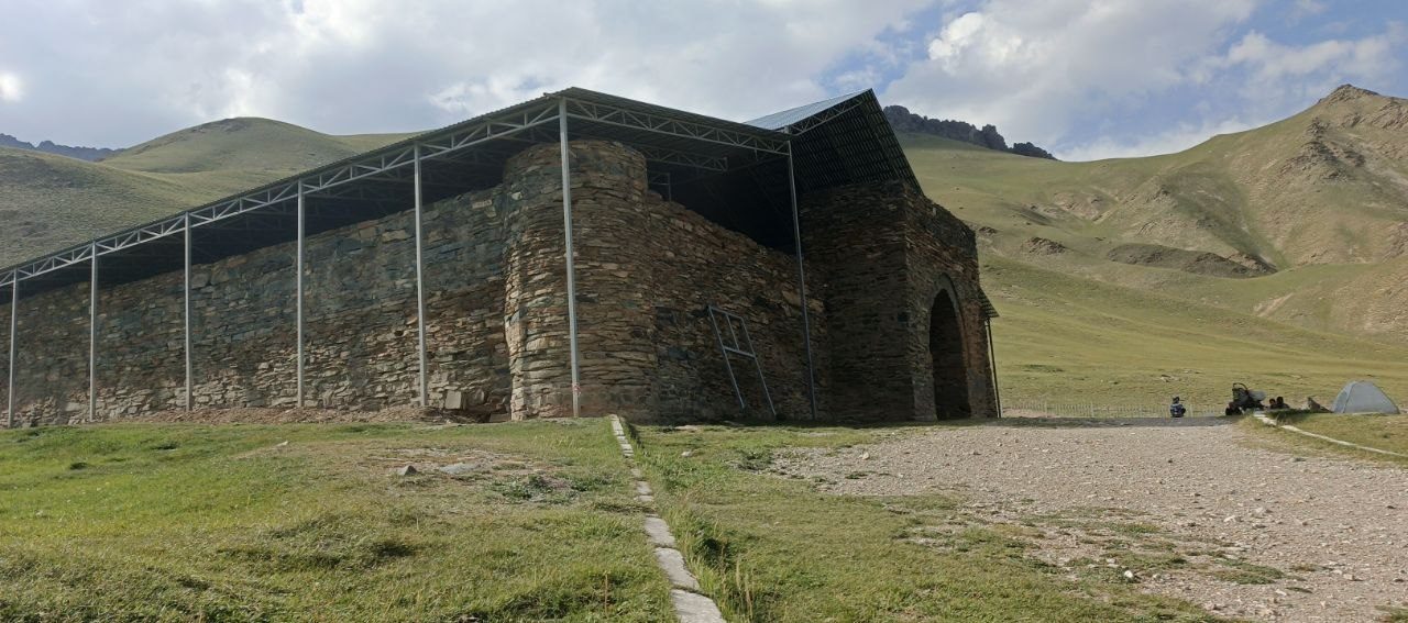 The stone Tash-Rabat caravanserai in a mountain valley