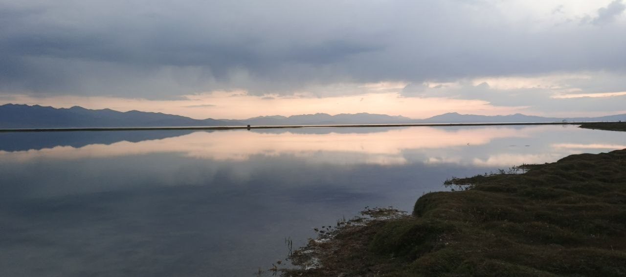 A mountain lake beneath an evening sky in Kyrgyzstan